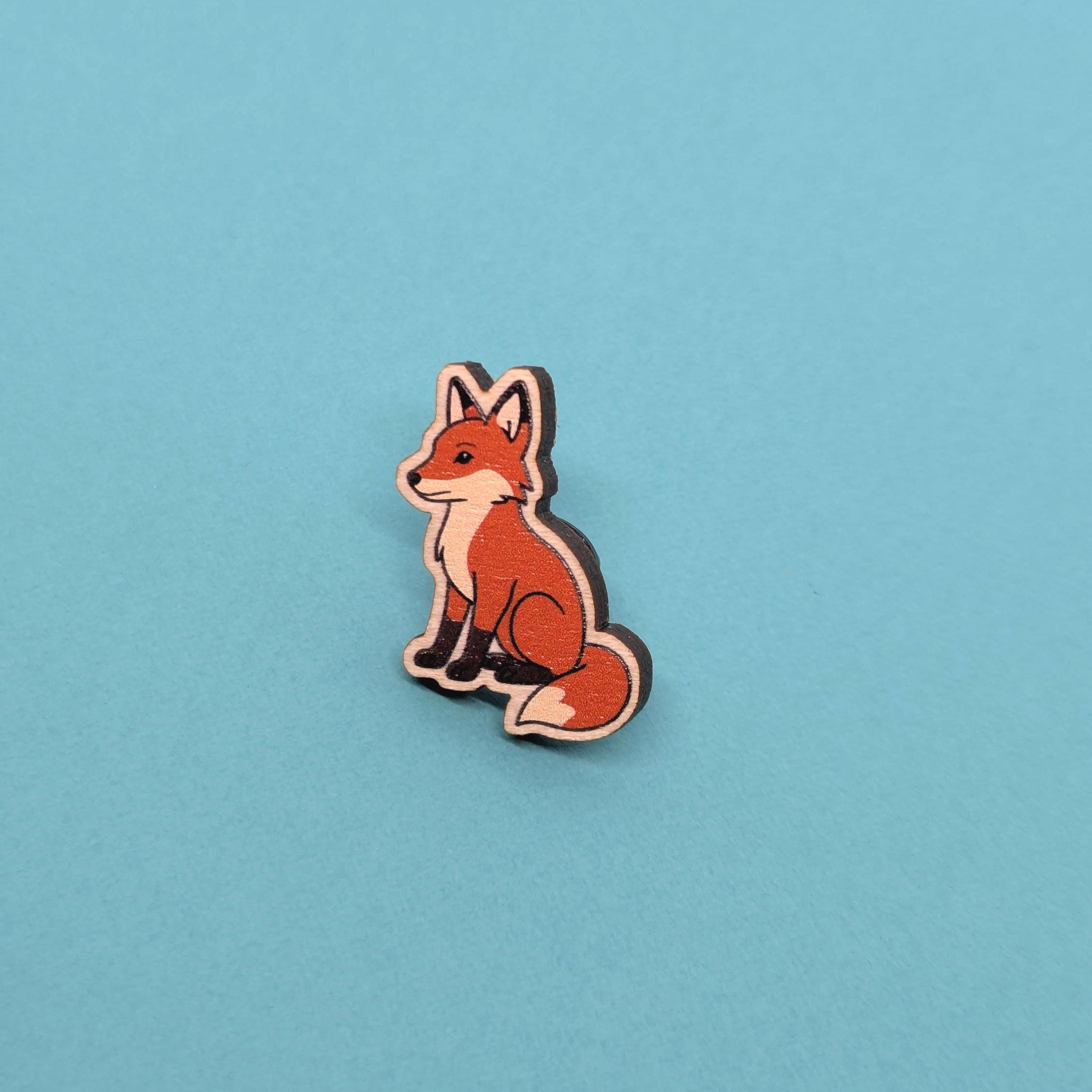 red fox wooden pin on a blue background
