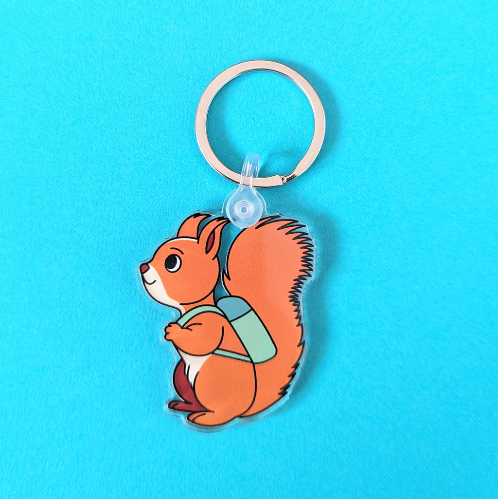 Keychain with a cartoon squirrel design on a blue background