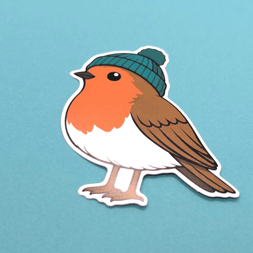 Sticker of a robin wearing a green beanie on a light blue background