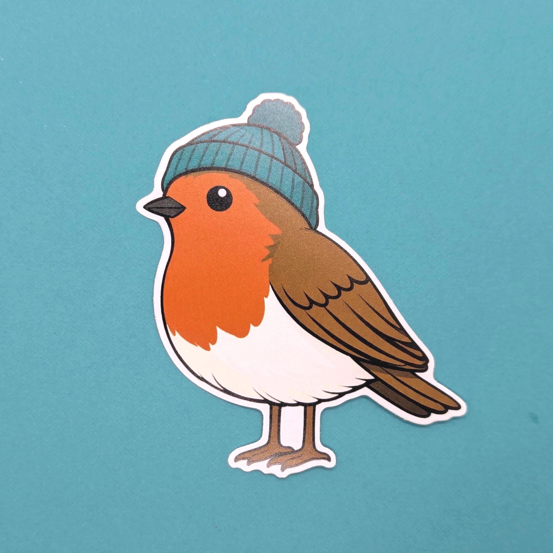 Sticker of a robin wearing a blue knitted hat on a teal background