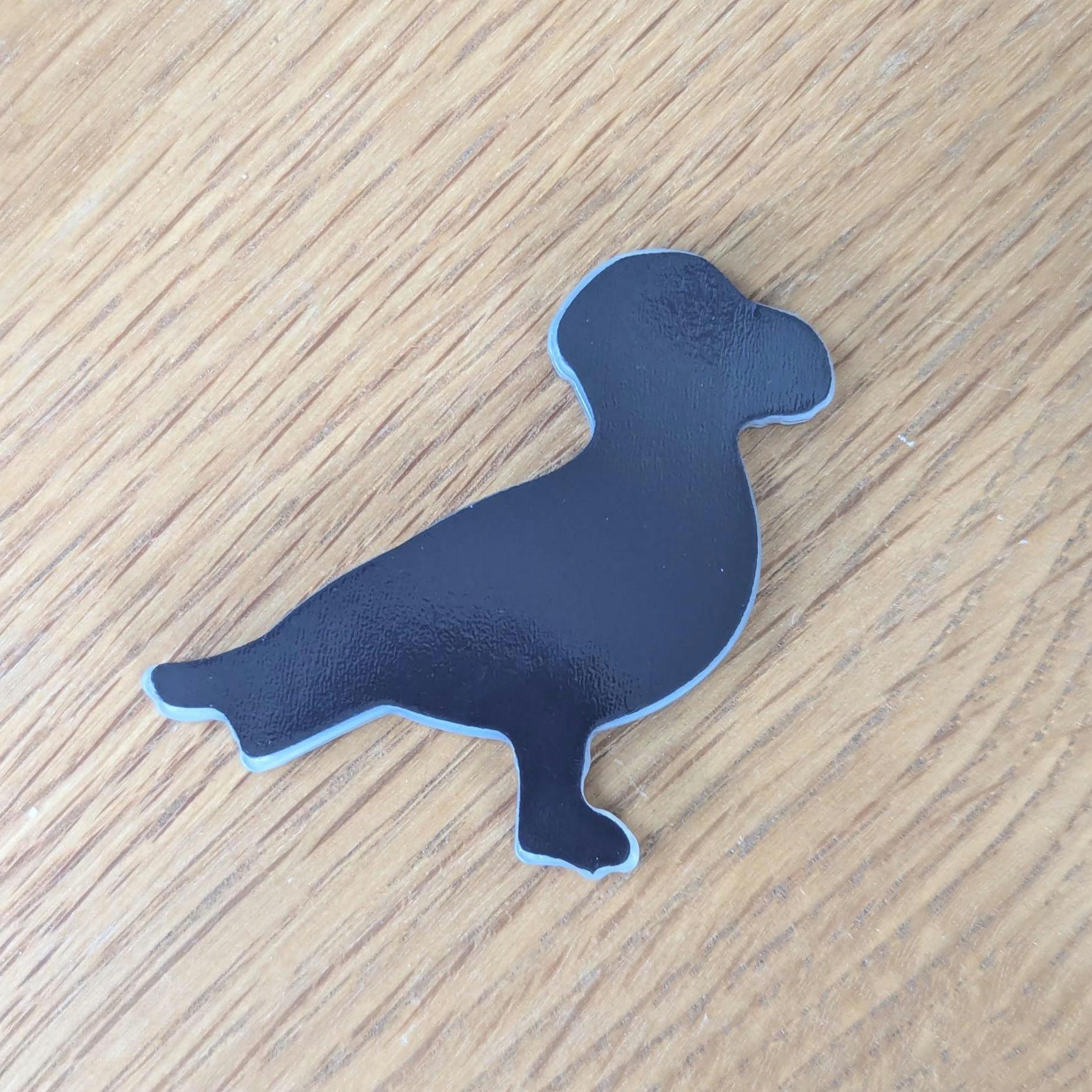 back of seagull fridge magnet on a wooden background