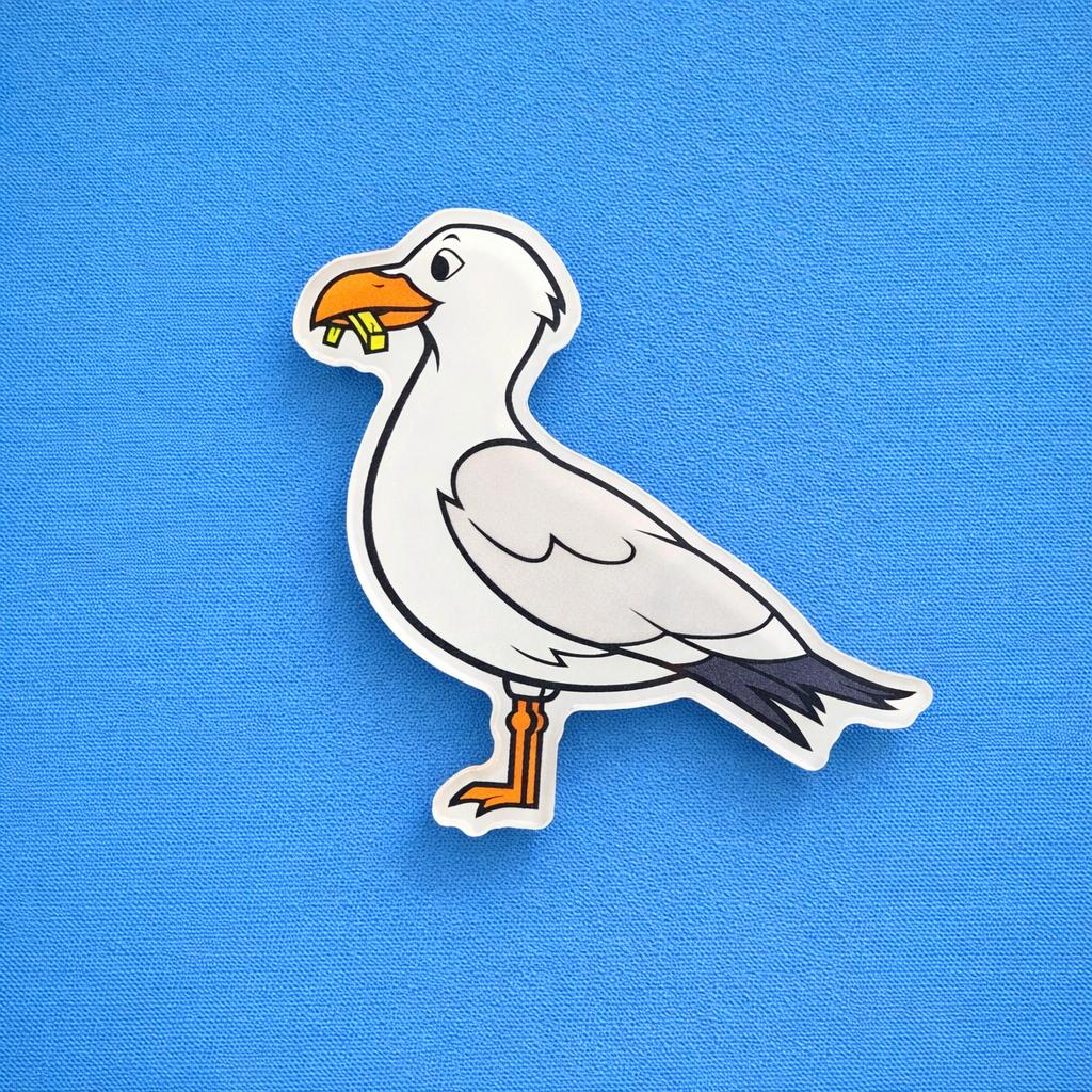 Cartoon seagull fridge magnet with a stolen chip on a blue background