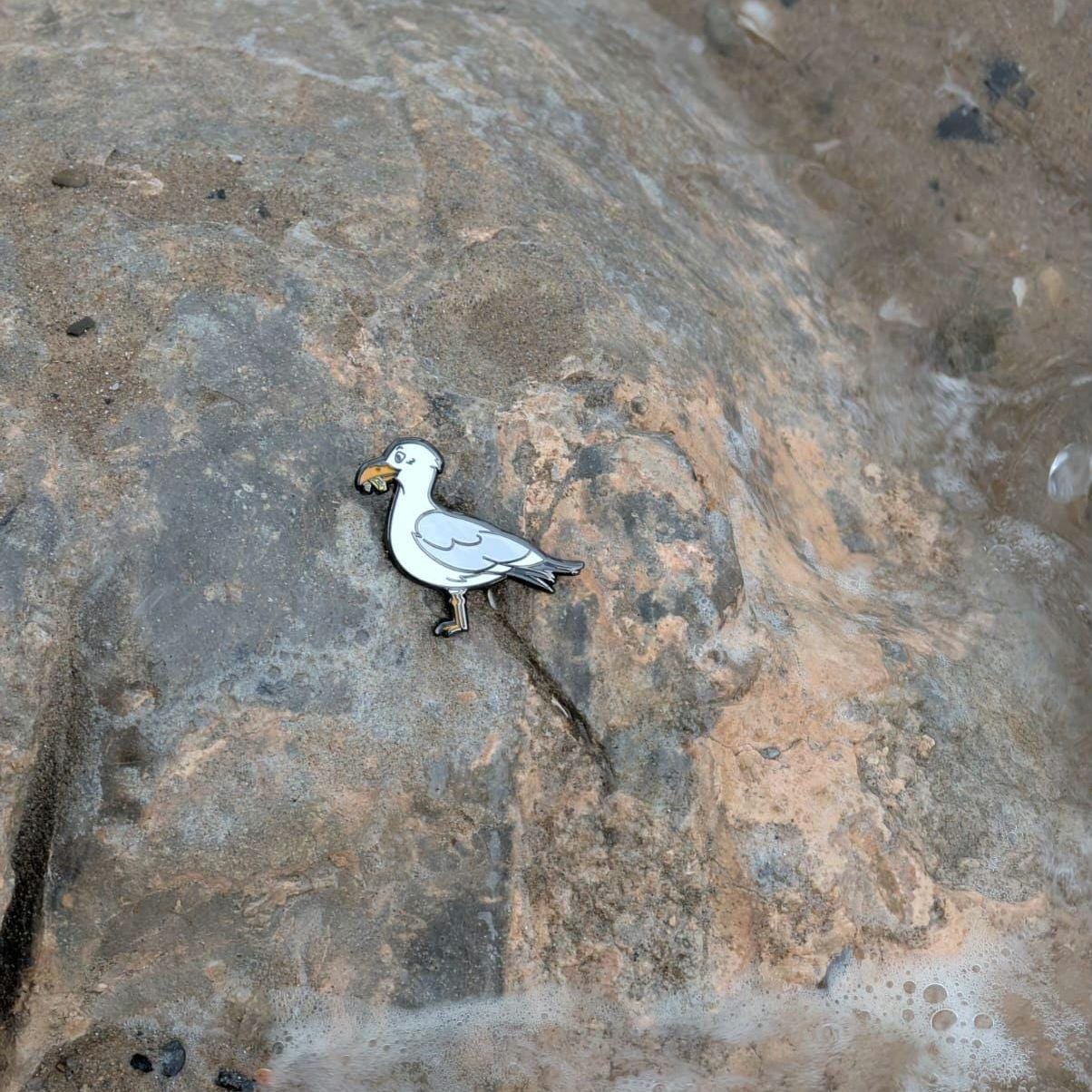 Seagull pin on a textured stone surface