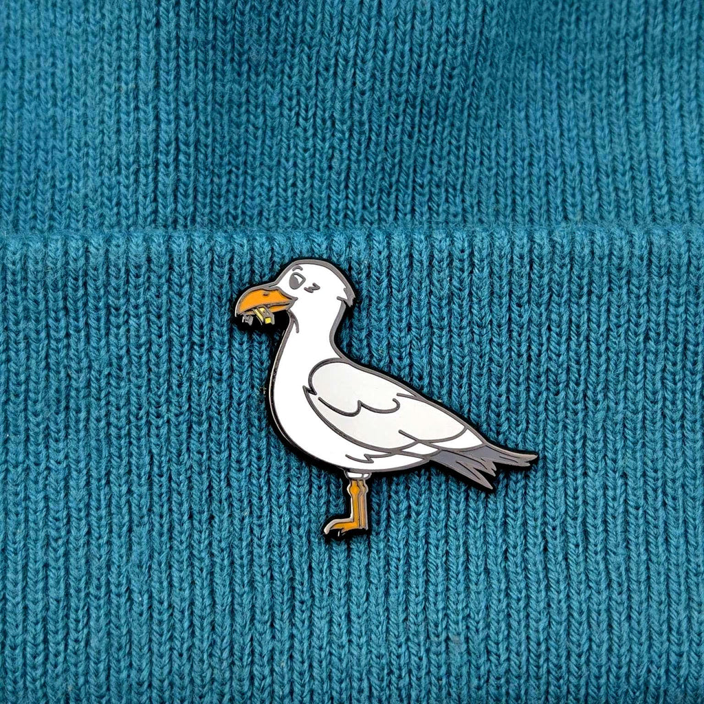 Seagull pin on a textured blue background
