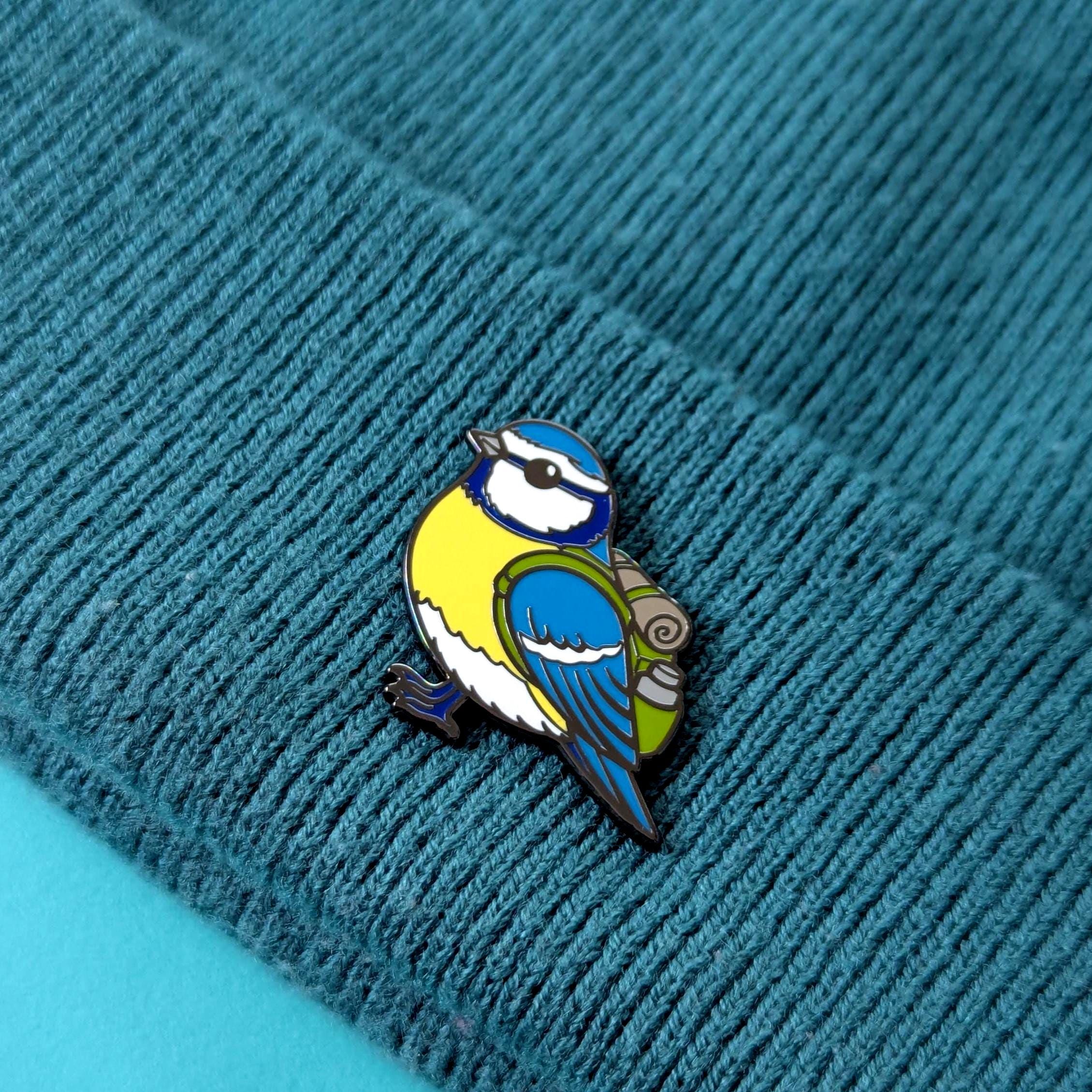 blue tit pin on a textured blue fabric background