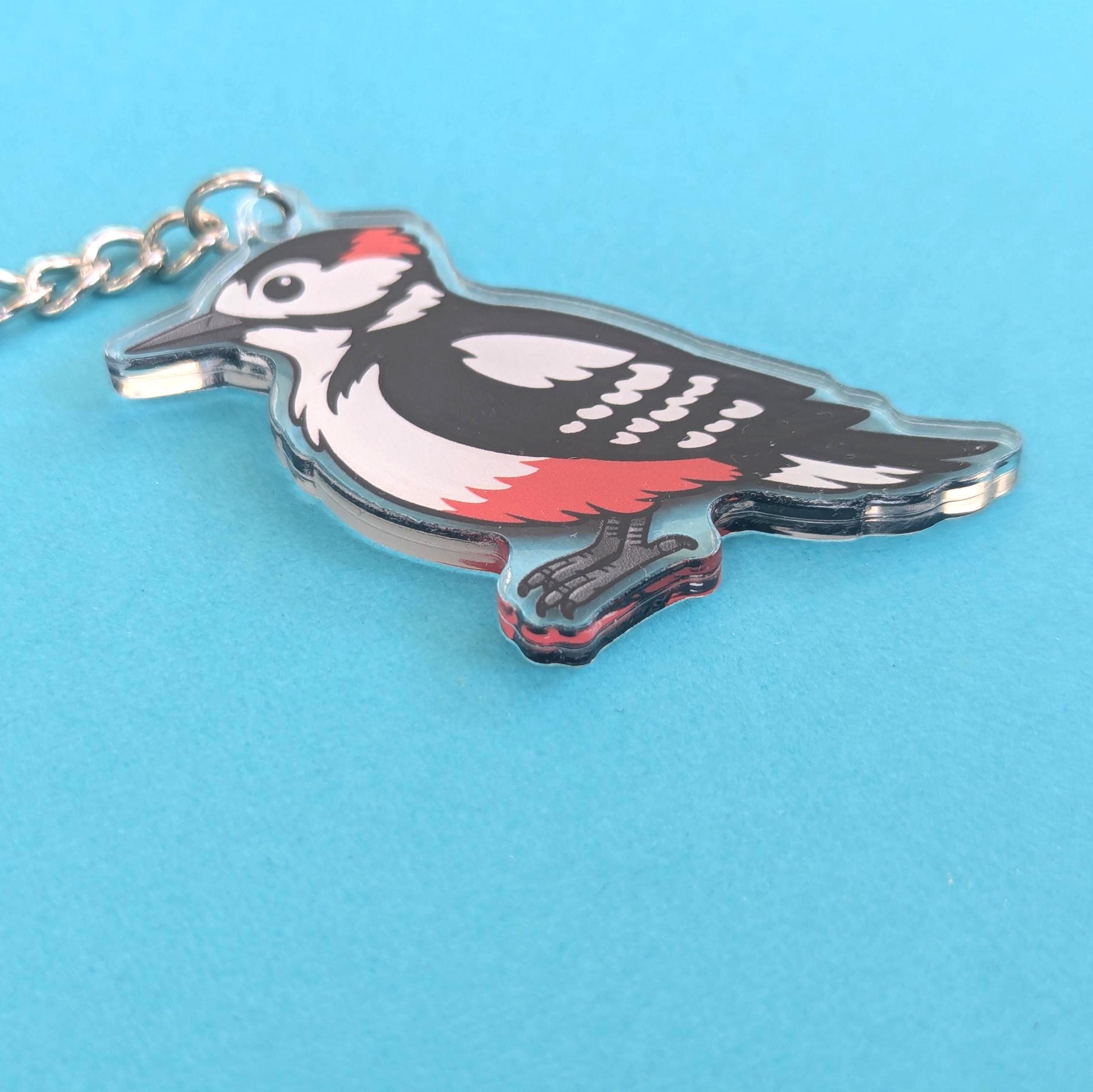 Woodpecker keychain on a blue background
