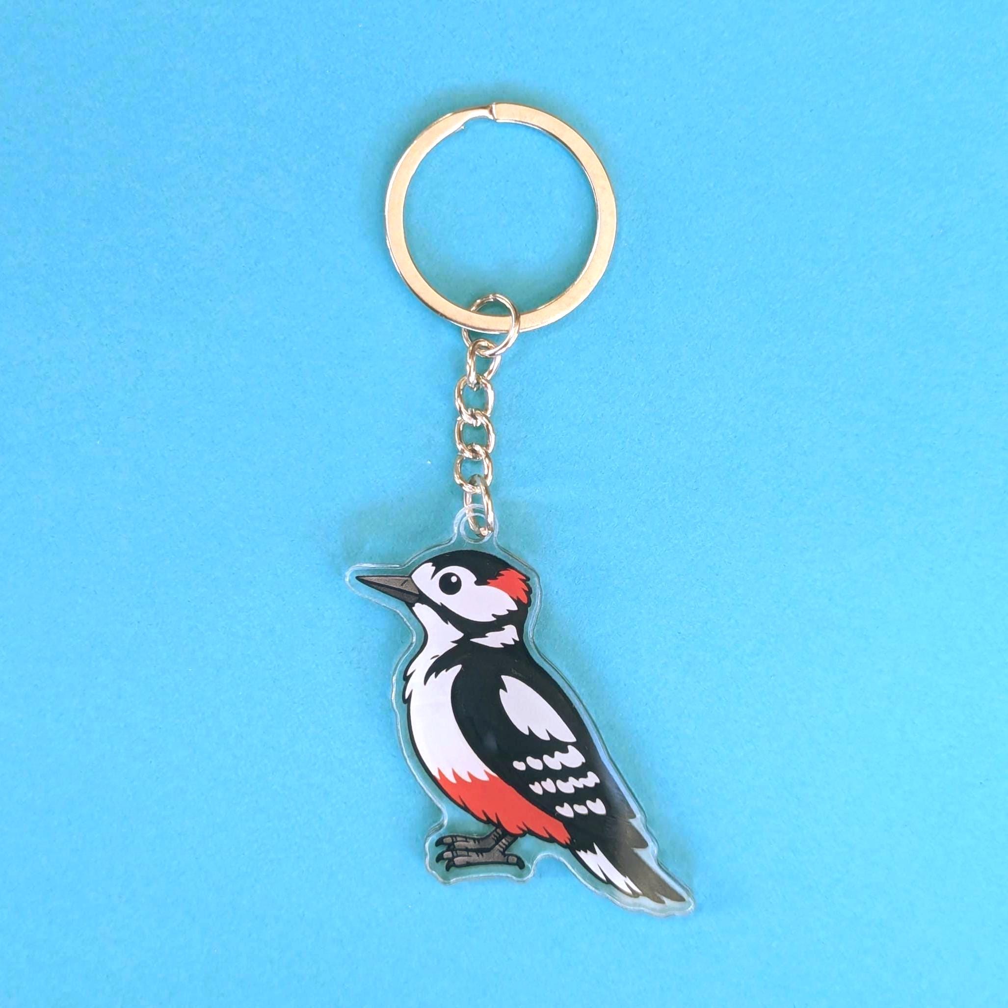 Woodpecker bird keychain on a blue background