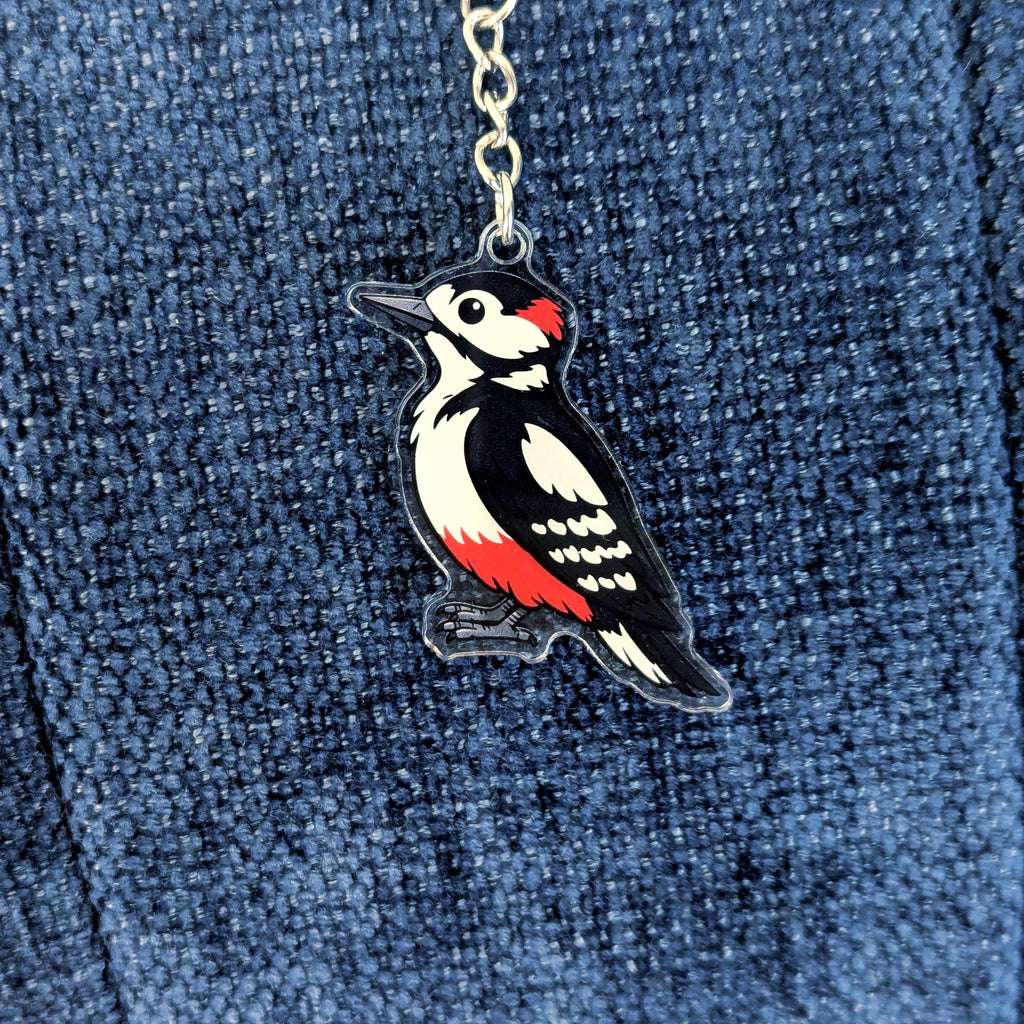 Woodpecker keychain on a blue denim background