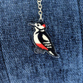 Woodpecker keychain on a blue denim background