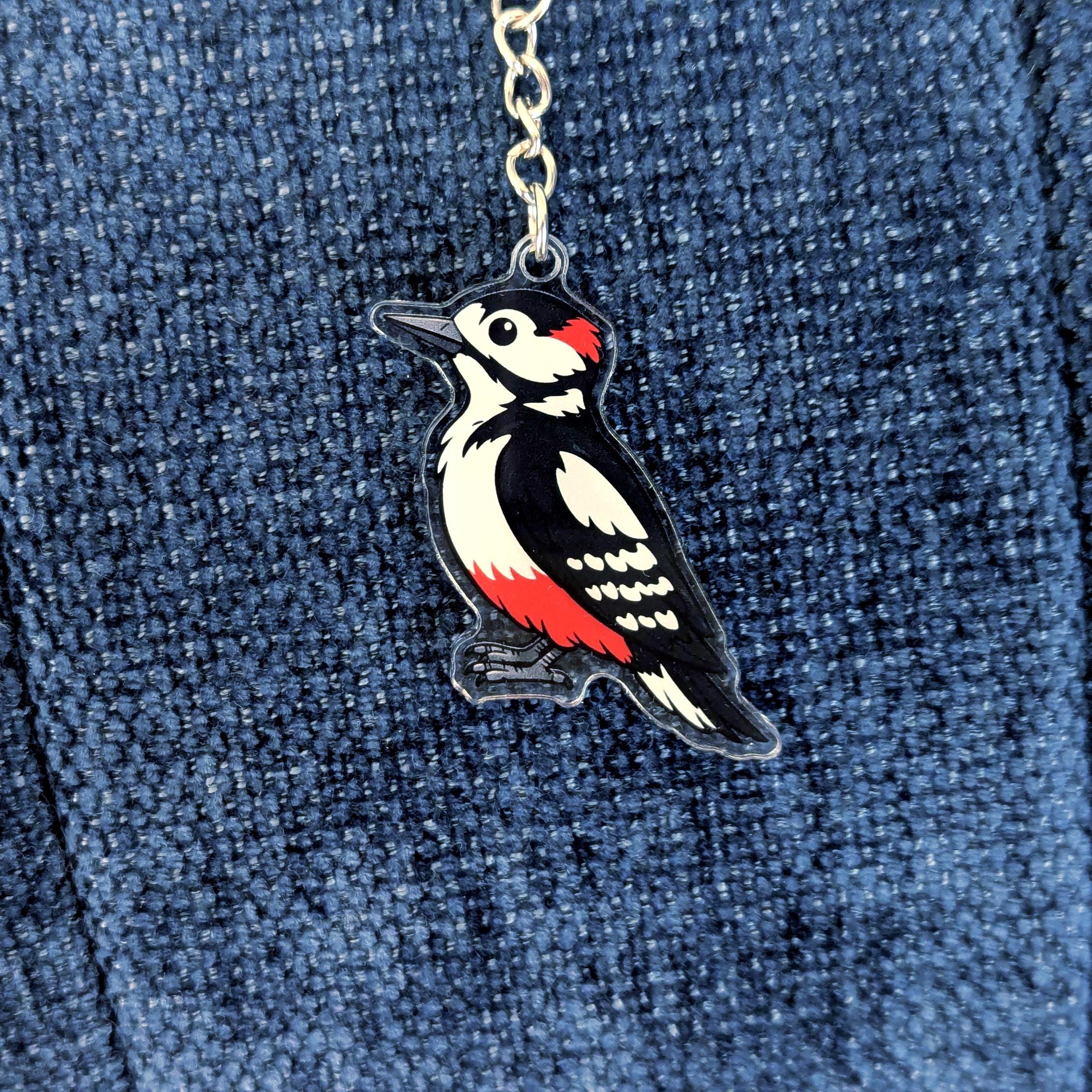 Woodpecker keychain on a blue denim background