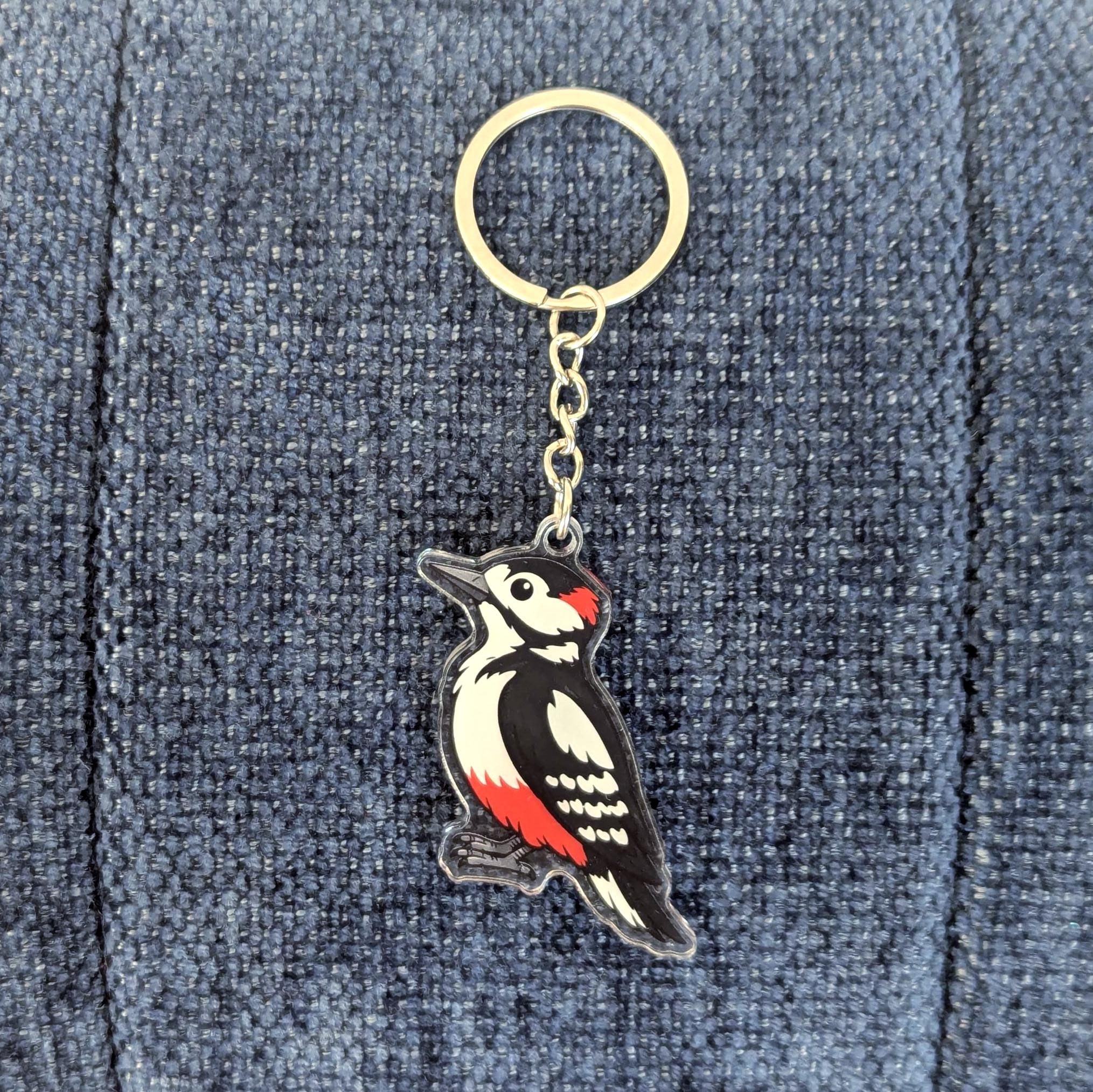 Woodpecker keychain on a denim background