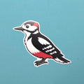 Sticker of a woodpecker on a blue background