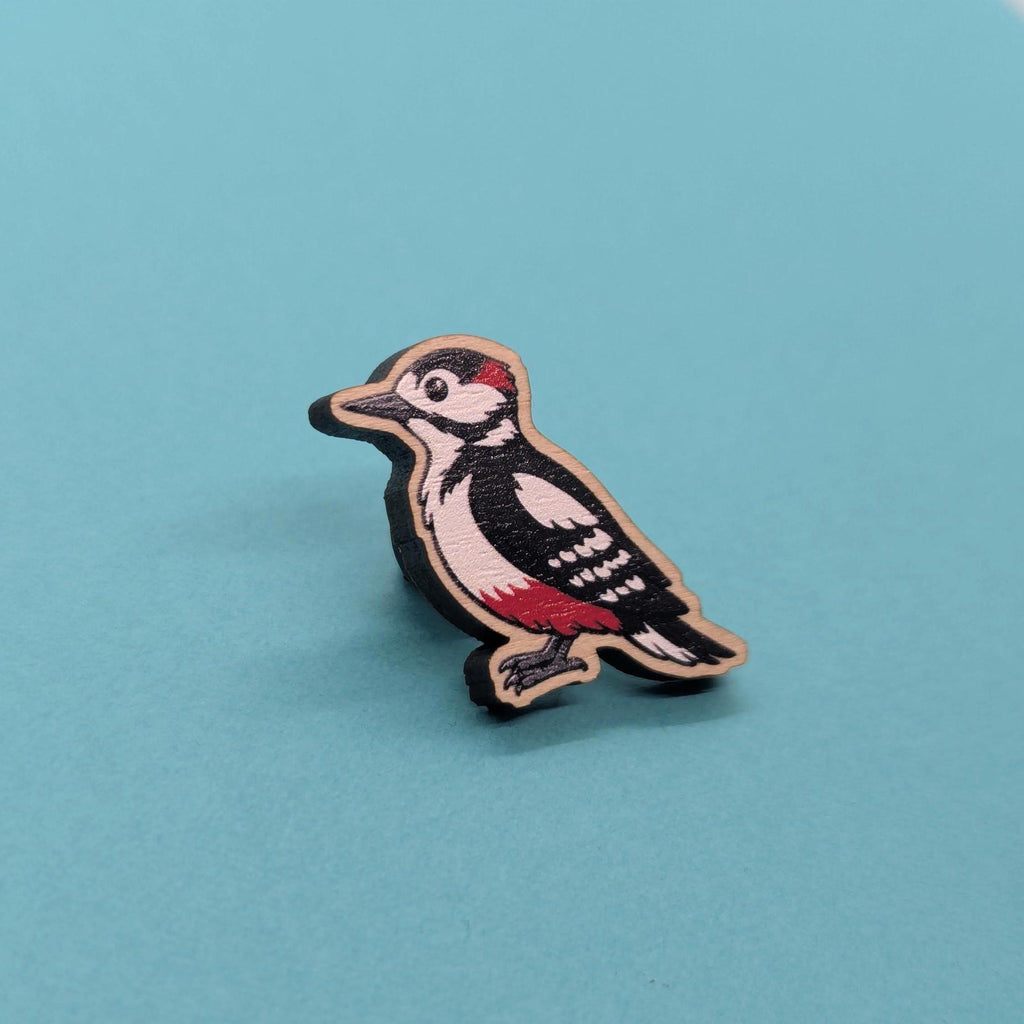 Woodpecker-shaped wooden pin on a blue background