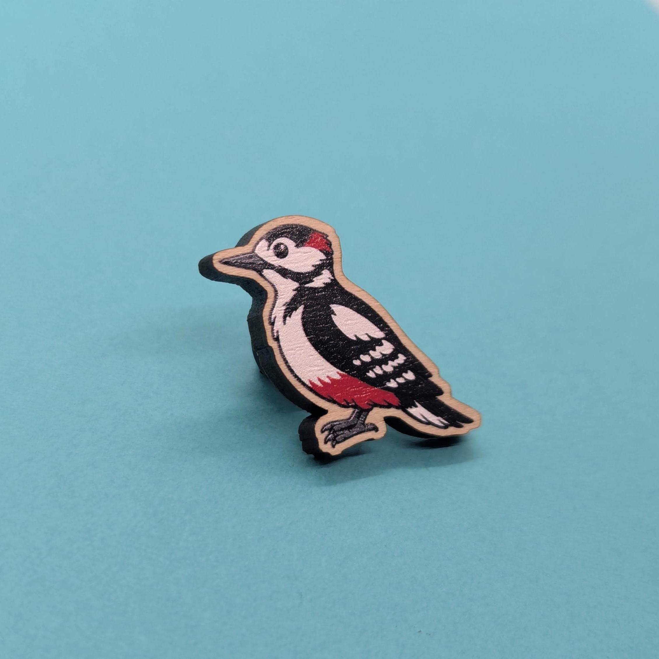 Woodpecker-shaped wooden pin on a blue background