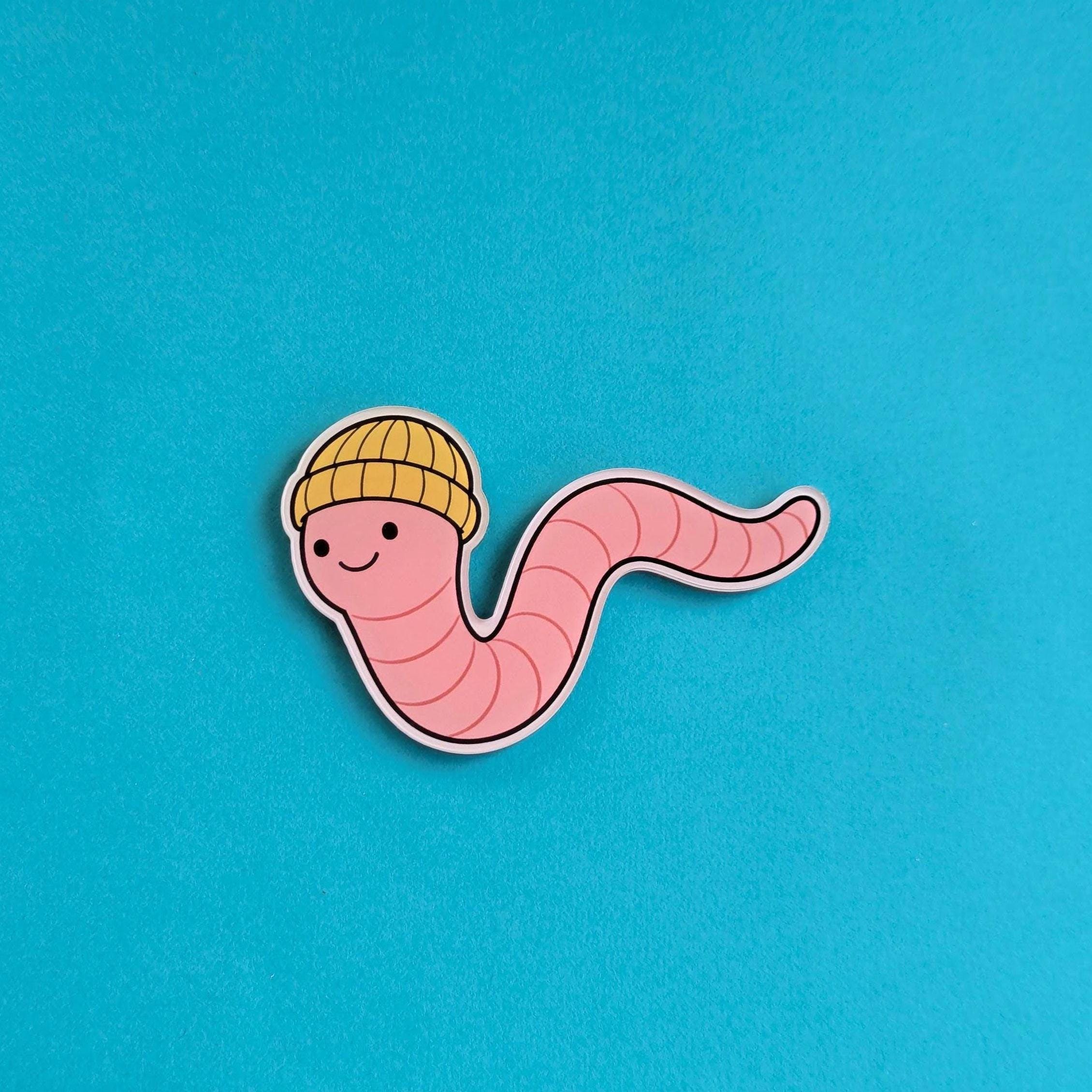 Fridge Magnet of a cartoon worm wearing a yellow hat on a blue background
