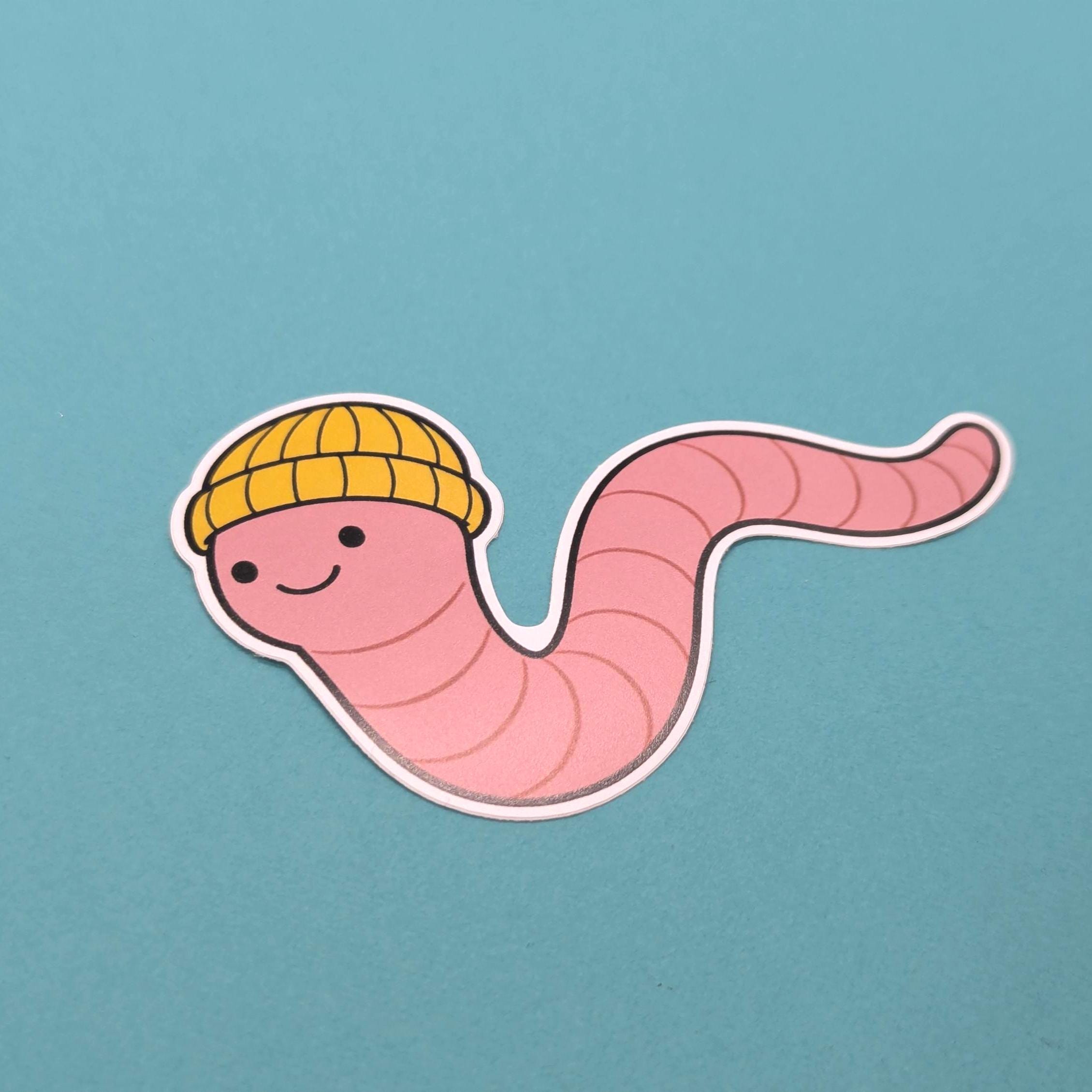 Cartoon worm wearing a yellow hat on a blue background